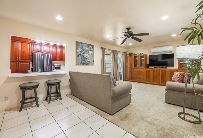 Living Room - Eat-In Kitchen, Built-In Cabinets, Ceiling Fan, Split AC, Area Rug, and Ceramic Tiles Flooring.