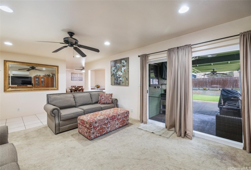 Living Room - Wall Mirror, Ceiling Fan, and Area Carpet.