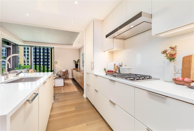 The Sub-Zero wine refrigerator (left, foreground) and refrigerator with freezer drawers (to the left of the range top) blend seamlessly with the cabinets.