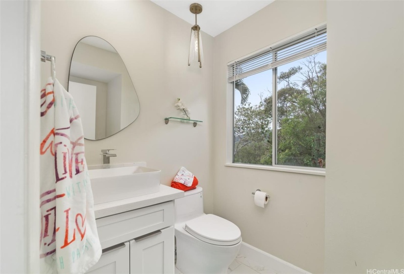 Convenient half bath next to the bar area and family TV room.