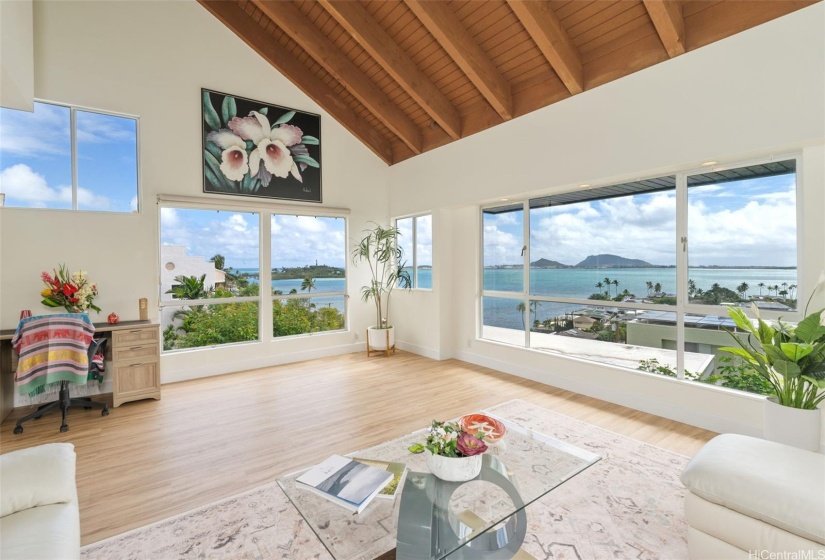 The large windows in the living room facing the ocean provide endless ocean views. The open floor plan maximizes the feeling of being connected to the outdoors and brings the ocean views inside.