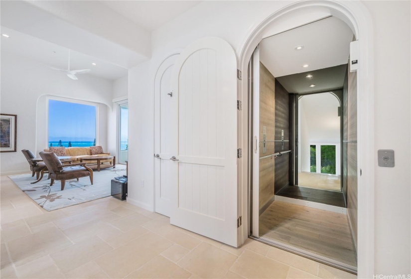 Seating area on the third floor of the home with views of the Pacific Ocean and an entrance to the elevator that allows access to all three levels of the home.