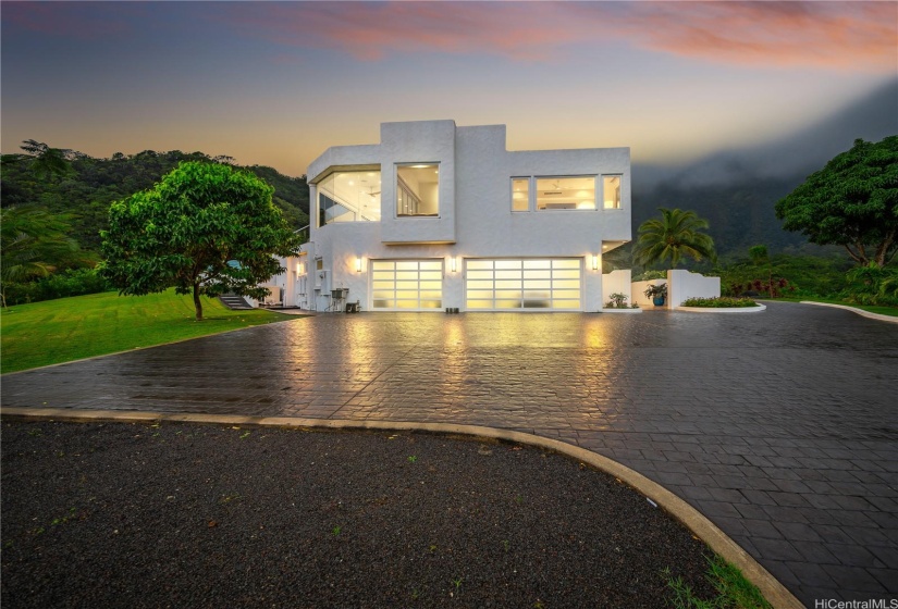 View of the property, garages, and additional parking as you enter from the front gate.