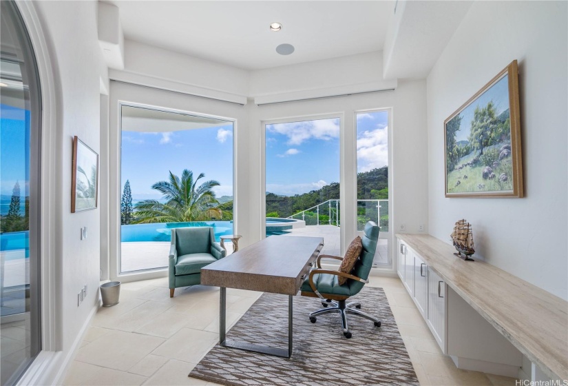 Office space looking out toward the infinity pool and Pacific Ocean, includes custom build-in cabinets and granite countertops.