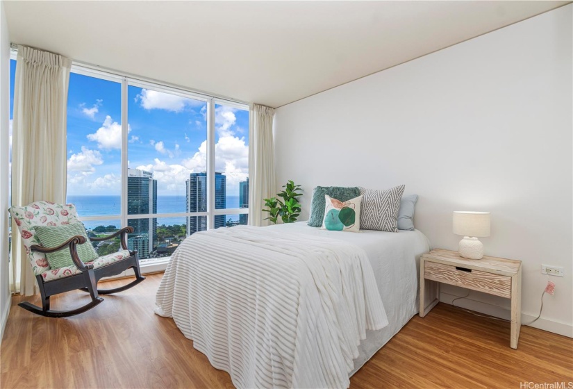 Secondary bedroom with views and floor to ceiling windows.