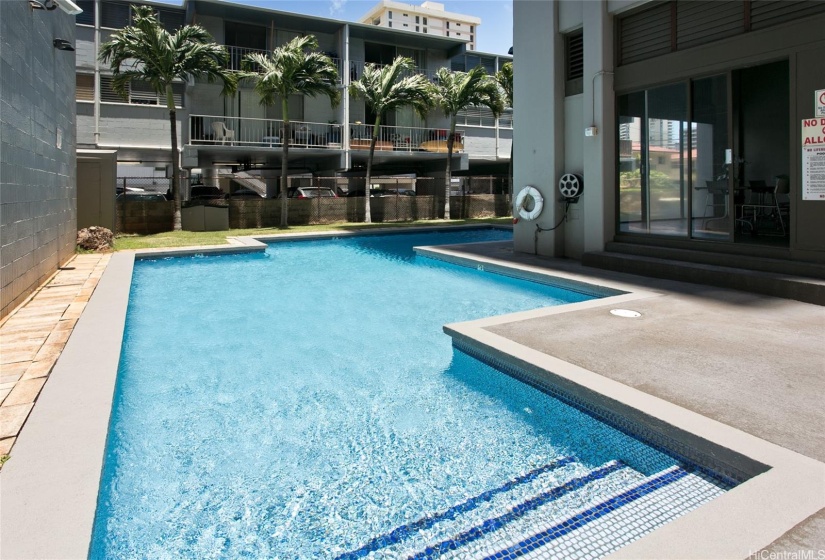 The association pool is delightful and the community room to the right is a lovely place to entertain.