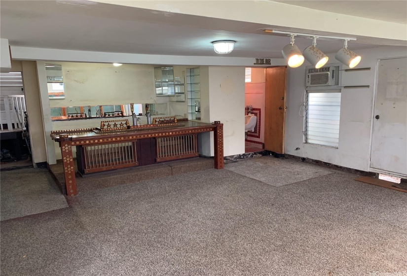 Recreation room: with view to partial bath with sink, toilet, & urinal.