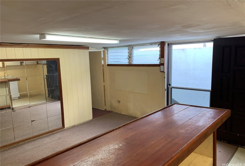 Unit 2 (Basement):  Front room with view to entry and bedroom