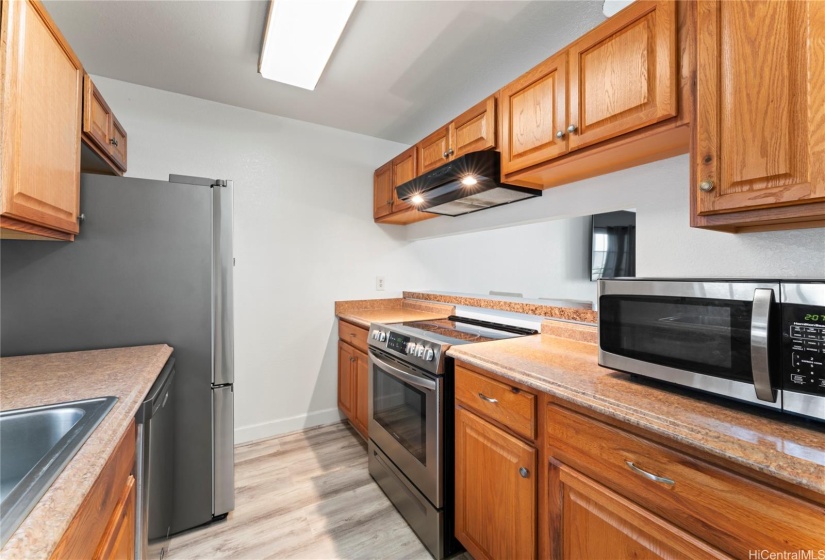 Luxury vinyl flooring extends into the kitchen.