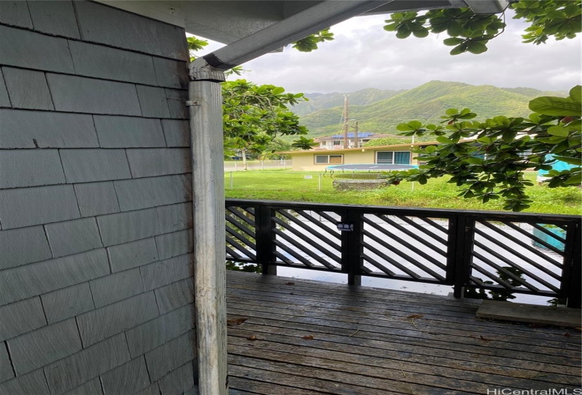 Spacious deck overlooking peaceful stream and mountain views.