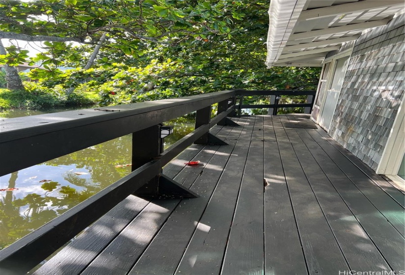 Spacious wrap around deck overlooking stream.