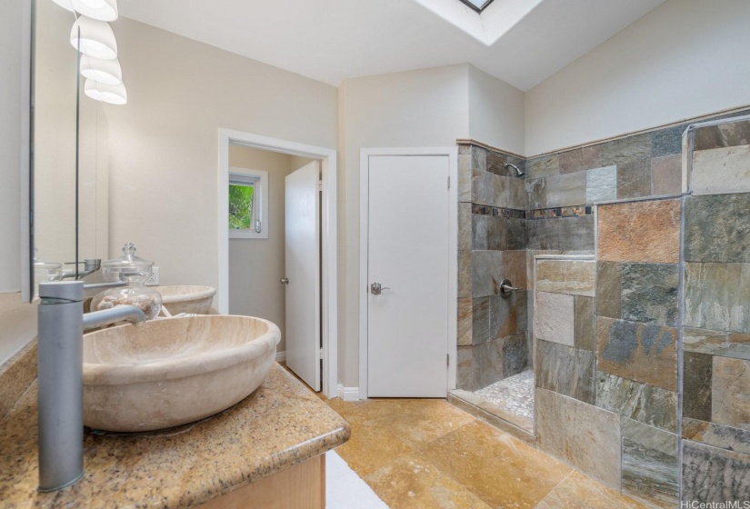 The large en suite bath features vaulted ceilings, a double vanity with vessel sinks, two closets and shower with TWO shower heads, and a water closet for privacy.