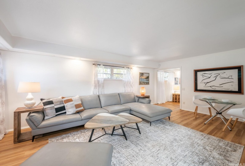 This spacious 728 sf in-law suite provides enough space for a full living room and small dining area.  The kitchenette is to the right in this photo, and the bedroom entrance is show in the upper right area of this photo.