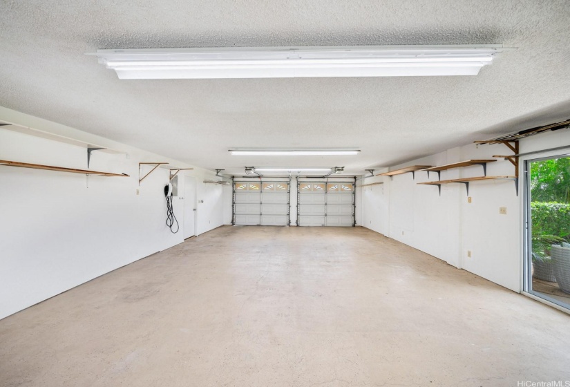 A massive 917sf 4-car garage with Tesla charger provides endless possibilities for a work room, home office, home gym, extension of the in-law suite.  Just bring your imagination, or your car collection!  Access the large ground level covered lanai from the garage and flex area.