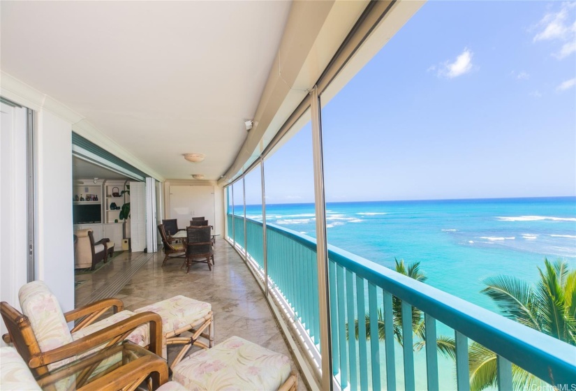 View from the bedroom end of the lanai. Look past the dining table to additional seating area and at the end is the second murphy bed.