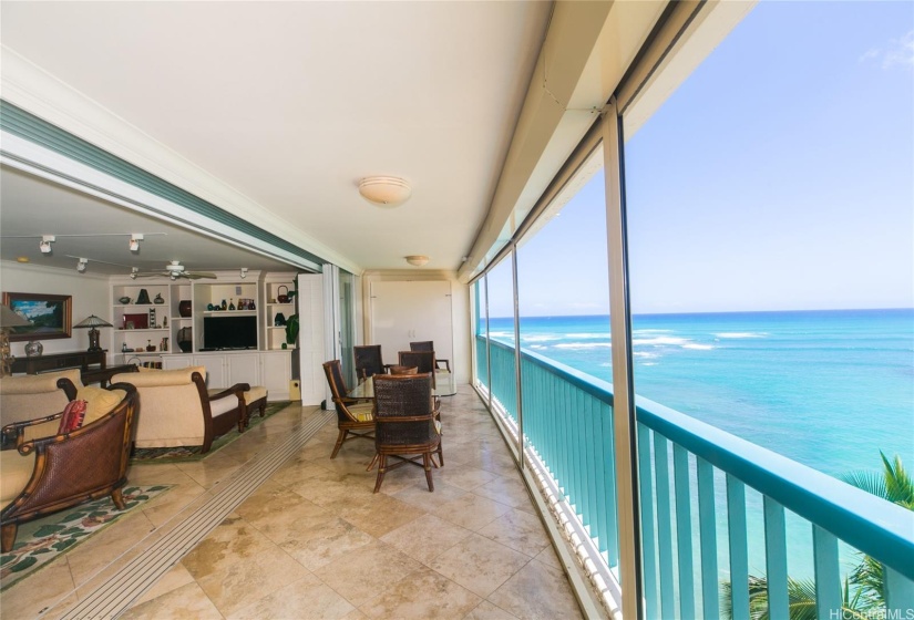 This condo has an extra large lanai with two seating areas and a full dining set.