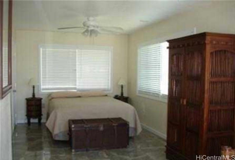 Bedroom on the upper floor flows out into the deck with views