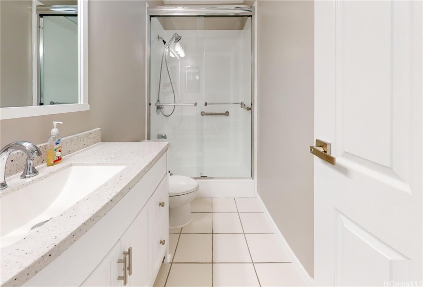 Shared bathroom with stand in shower