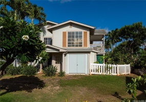 Your front door faces a grassy area with a Plumeria tree.