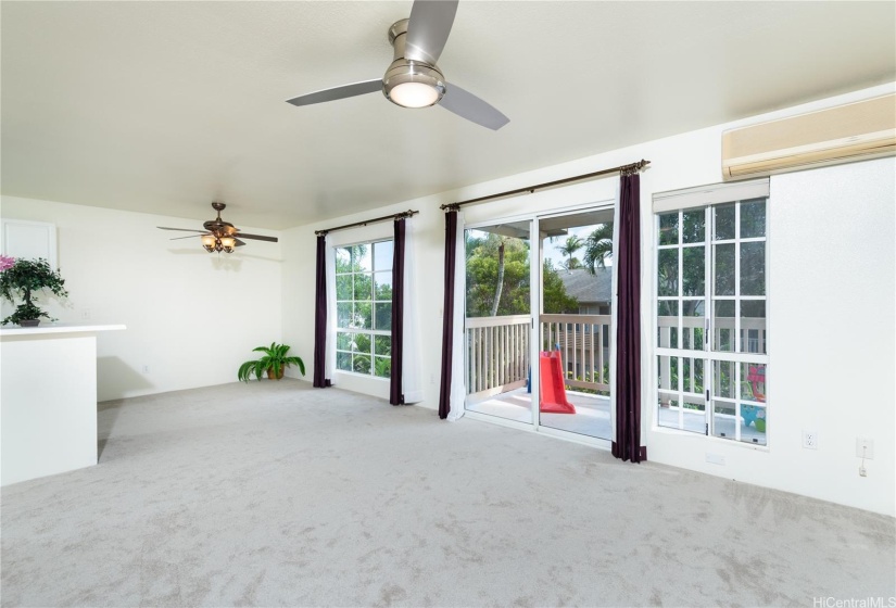 Living room is large, light and airy with AC, and two fans.