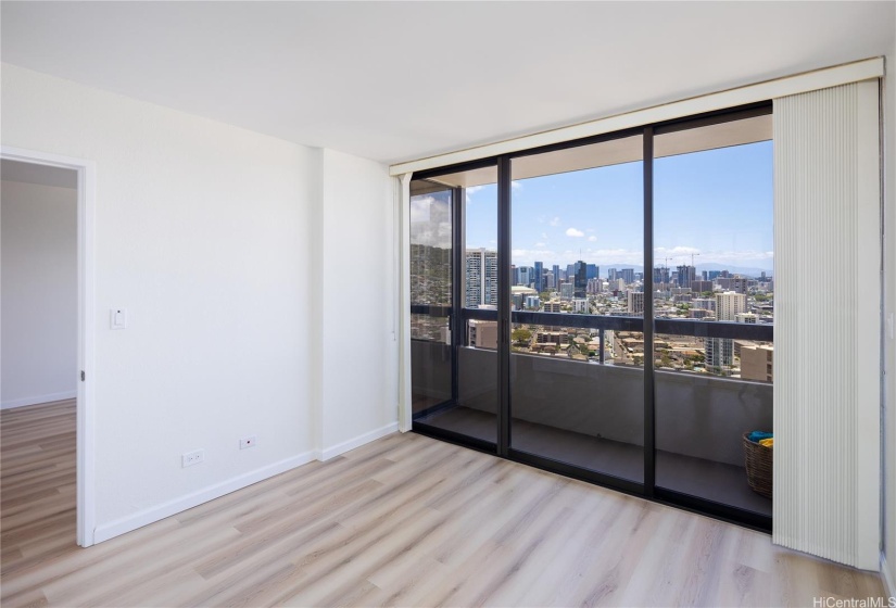 Sliding glass doors glide open with ease. Bedroom view toward Ala Moana Center and beyond.