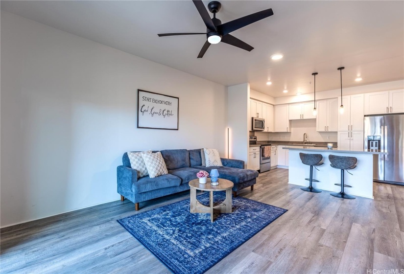 Open concept Living Room with large vinyl plank flooring.