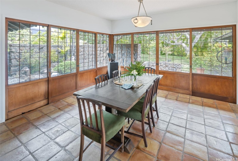 The lush front yard brightens the dining room vistas.