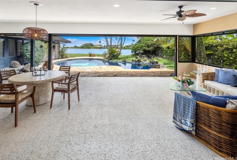 Step outside of the sliding glass doors onto the covered lanai.