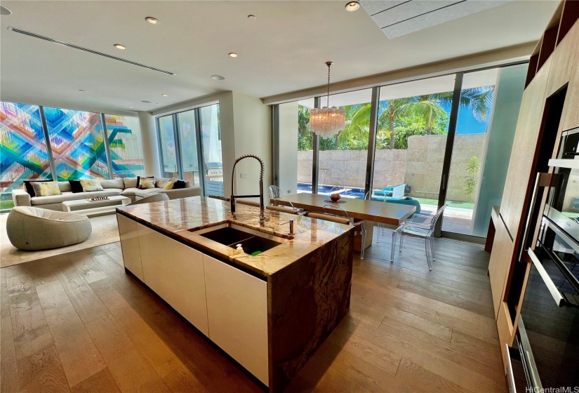 Kitchen to living room; note also the outdoor kitchen with BBQ, sink, and refrigerator