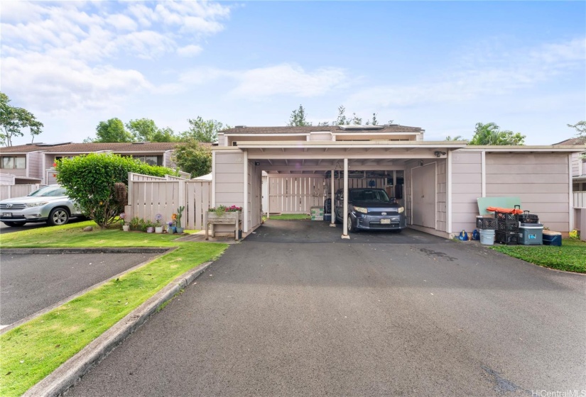 Carport straight ahead (left side), two tandem parking behind carport, one stall on left side of the photo (carport storage closet not pictured)