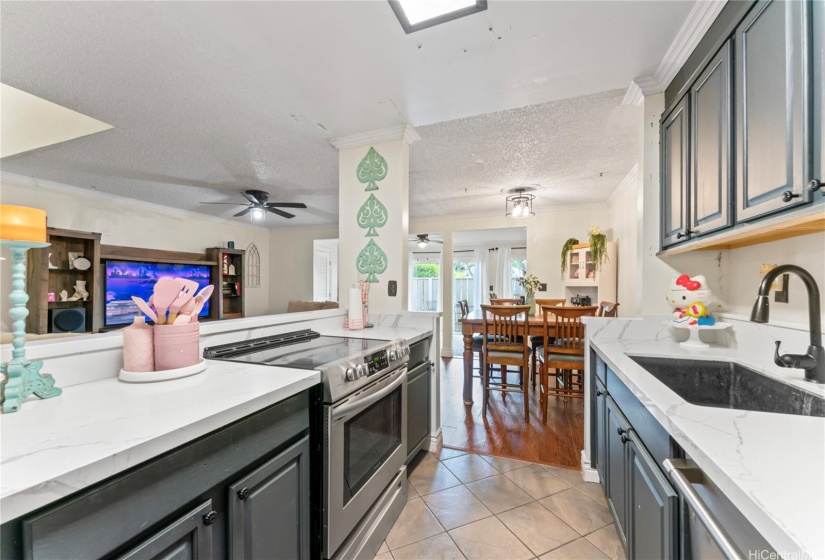 Kitchen opens to dining room/living room (glass cooktop stove)