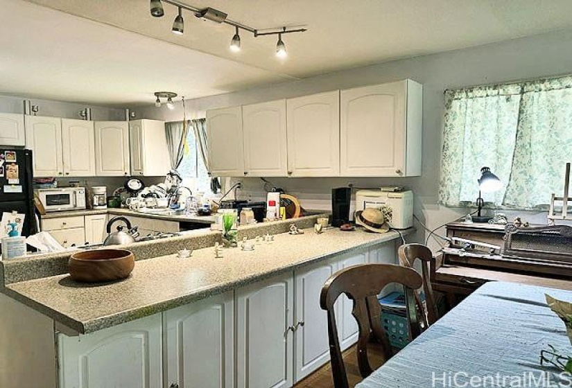 Dining area with breakfast bar looking into the kitchen.