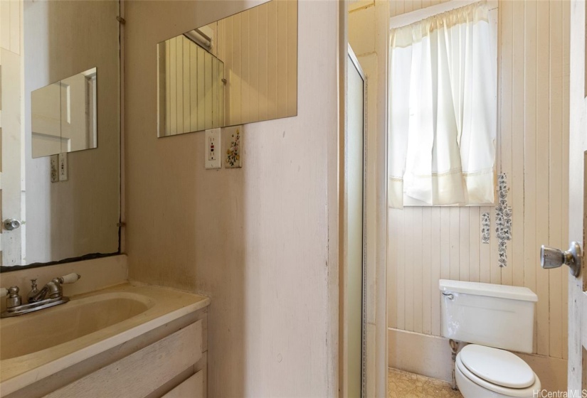 Bathroom is opposite the kitchen and has a shower and linen closet behind the door on the right.