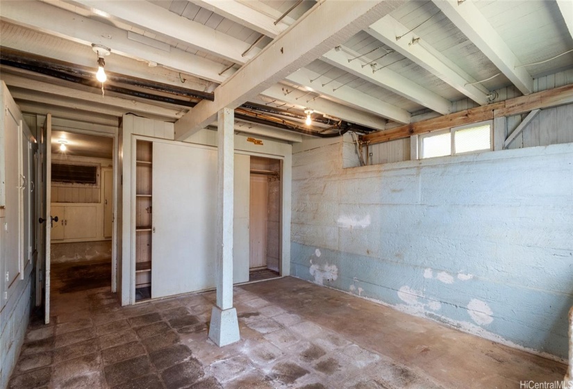 Another huge room in the basement. This room is to the right of the carport and has a closet in addition to built in storage cabinets. It has the potential for many different uses.