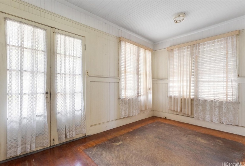 Light and bright living room. Original wood floors are discolored but otherwise in good shape.