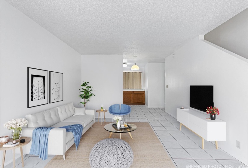 The second living area is equipped with ample room and a complete kitchen setup. This photo is virtually staged. Enhanced.