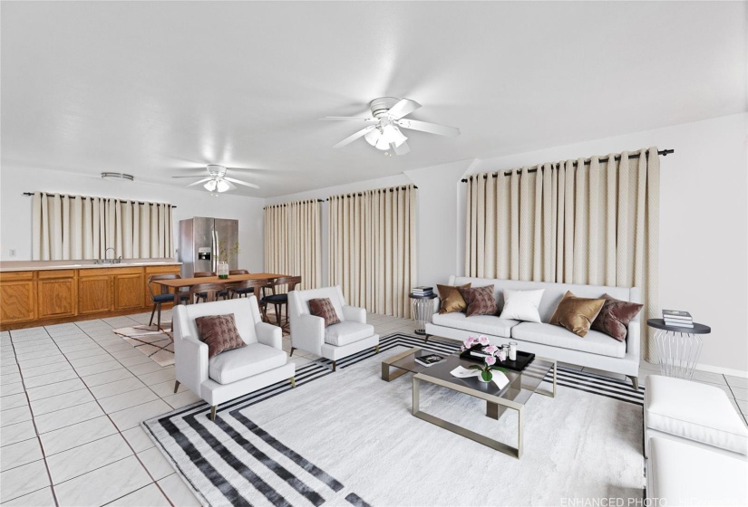 One of the two common living areas boasting abundance room and includes a wet bar for added convenience. This photo is virtually staged. Enhanced.