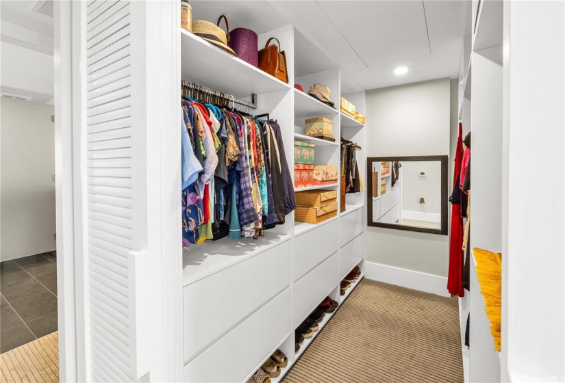 Walk-in closet with sliding door in the primary bedroom