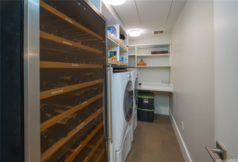 Laundry room is also customized by California closet. Sliding shelves above W/D are wide and deep, very practical! (Wine cooler is not included)