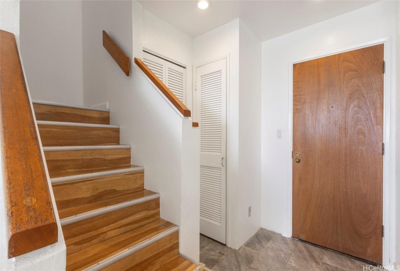 Stairs to bedrooms and bathrooms, closet space to the right of stairs and dedicated laundry area, pantry, and additional storage under the stairs!