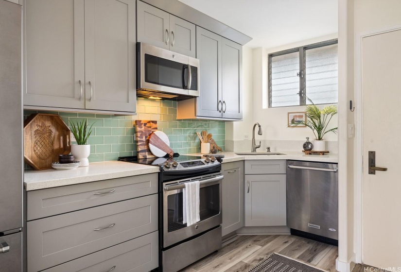 A custom kitchen where a full sized oven, microwave hood and dishwasher was incorporated into the design.