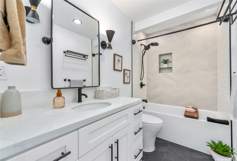 Bathroom #1 - look at those herringbone tiled floors and tub wall!