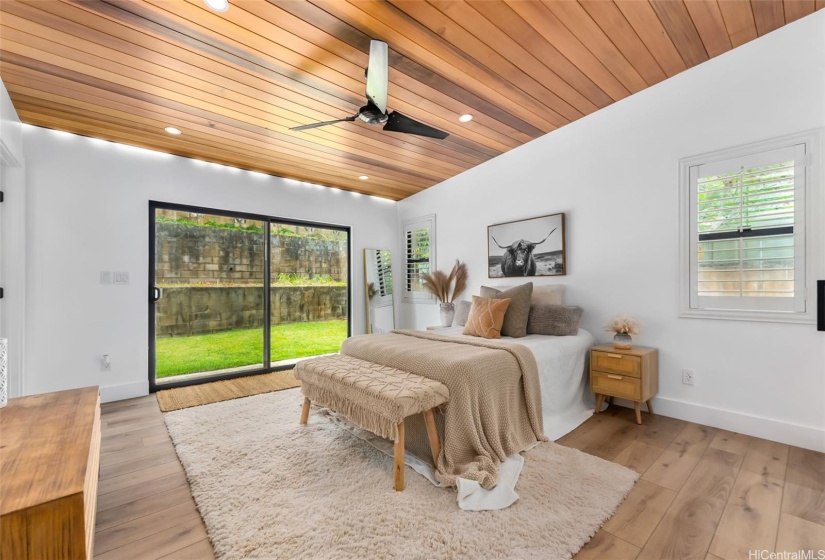 Primary bedroom w/ oversized sliding doors to access the backyard