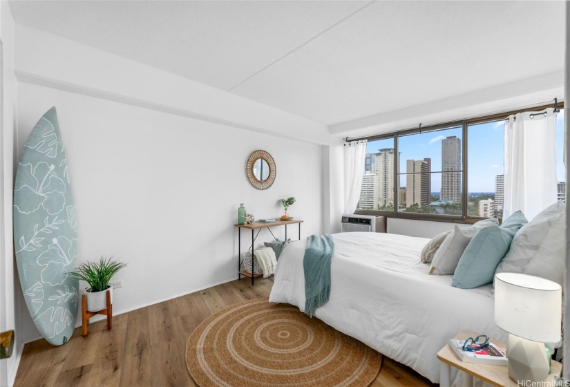 The primary bedroom offers stunning views of the city and horizon