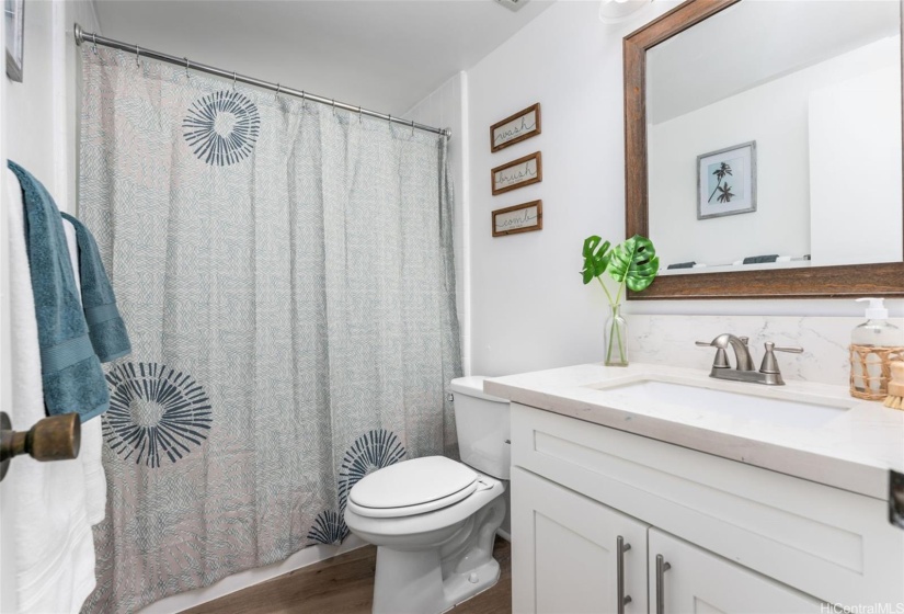 The hallway bathroom showcases a newly glazed tub!