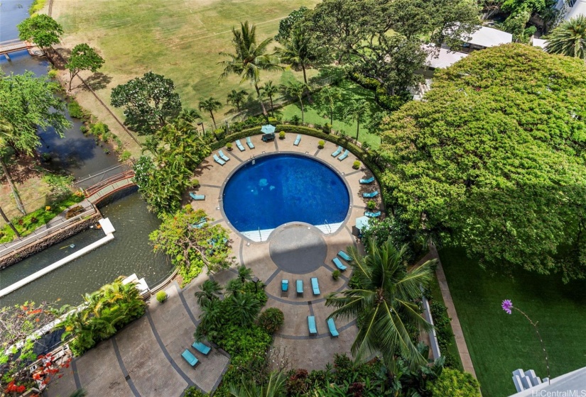 A swimming pool is situated in the oceanside garden area of the building