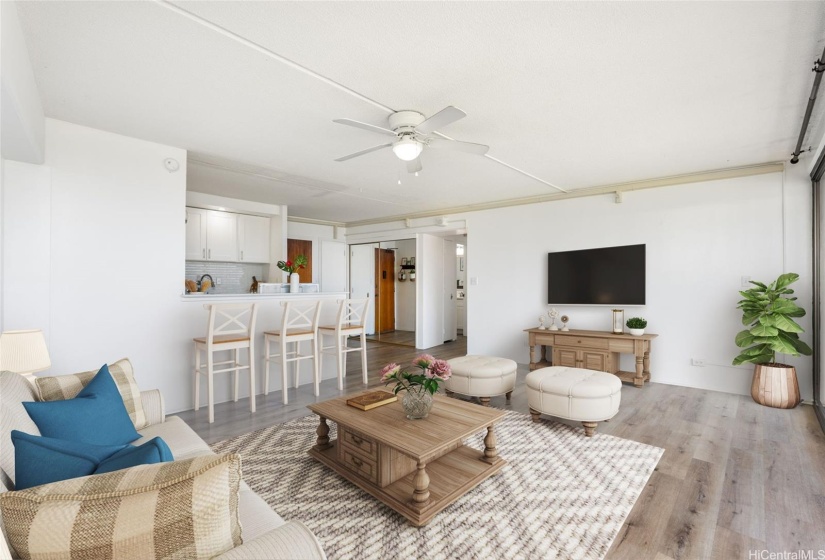 This recently renovated home seamlessly integrates the kitchen, dining, and living areas with a spacious, covered lanai.