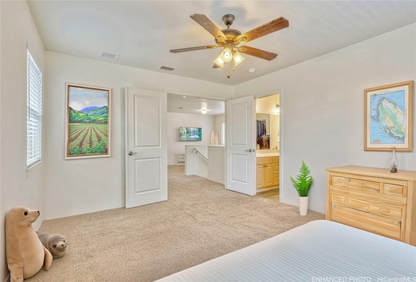 Primary Bedroom off of second floor landing. Virtually staged & enhanced.