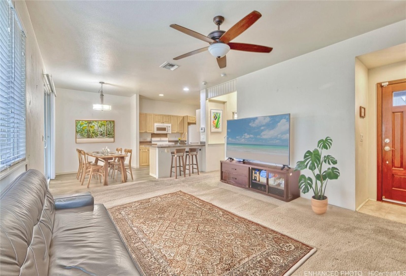 First floor living area, dining area, & kitchen. Virtually staged & enhanced.