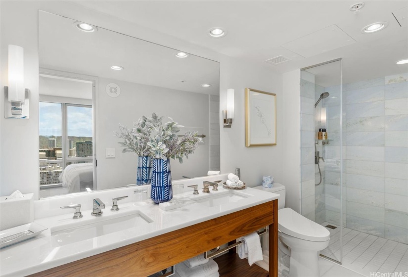 Sizable second bedroom ensuite with double sink vanity.